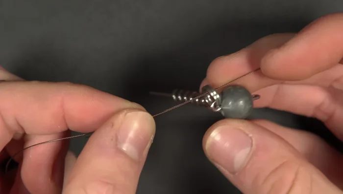 Screw in jig head into soft plastic lure.