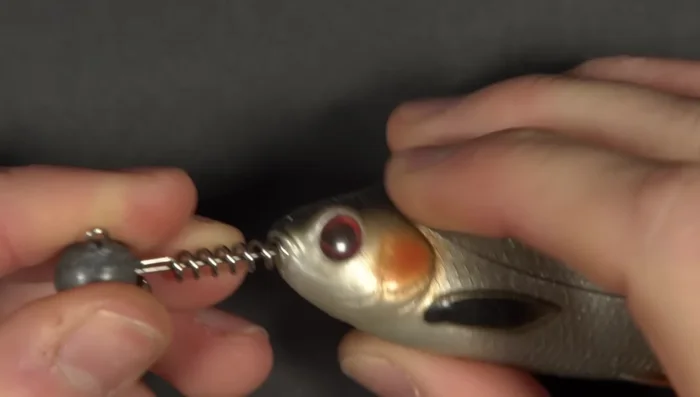 Screw in jig head into soft plastic lure.