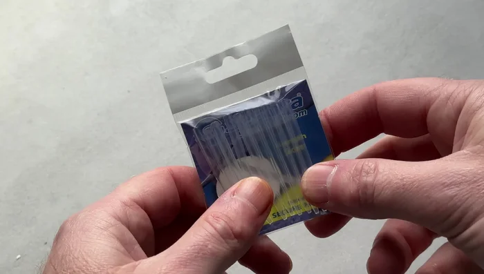 Pass the tag end into the hole and push the whole thing over the top of the swivel.