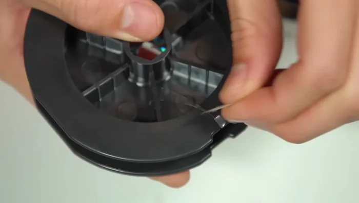 Thread the line through the rod guide and tie it to an empty spool with an arbor knot.