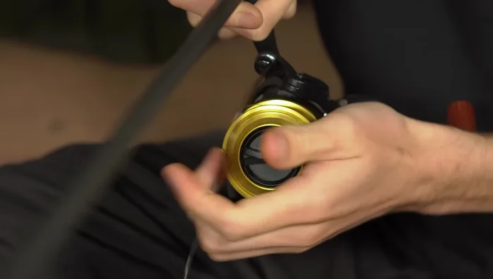 Apply tension to the line and reel it onto the spool until it's almost full (leave a couple of millimeters).