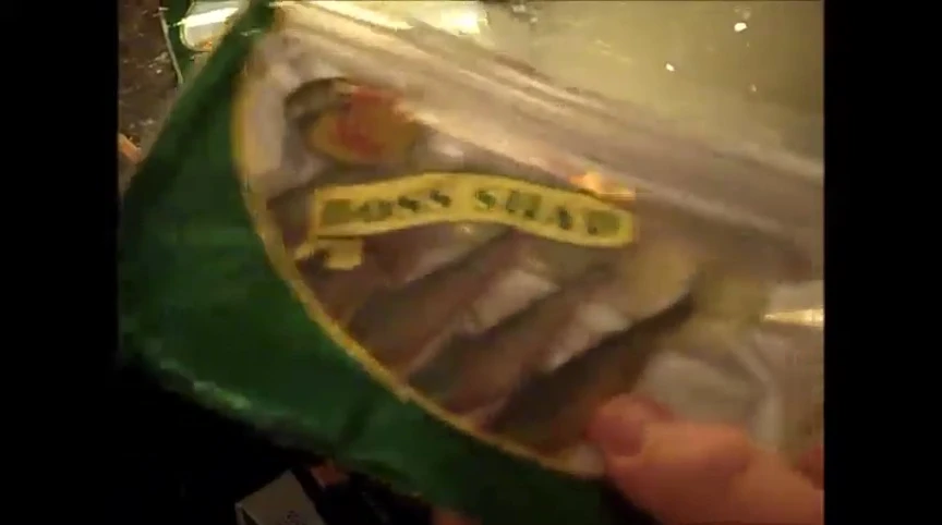 The speaker opens the packaging of the Boss Shad swimbaits.
