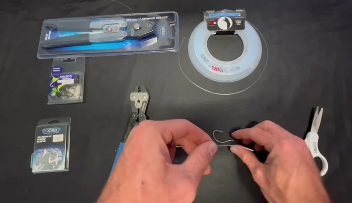 Attach your hook or swivel (in this case, a circle hook) through the leader and crimp.