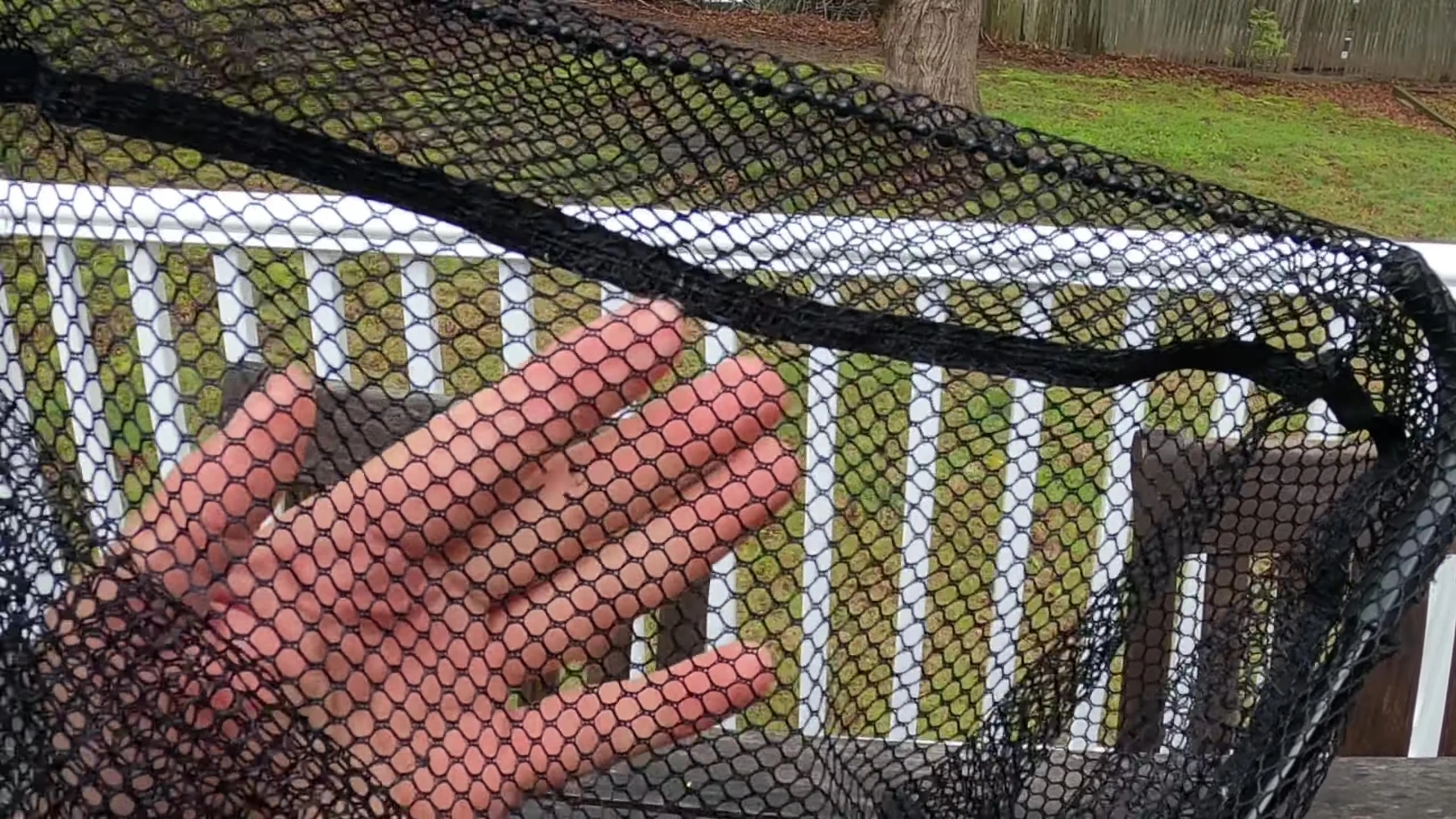 Close-up showing holes and snagged lure in the fabric net