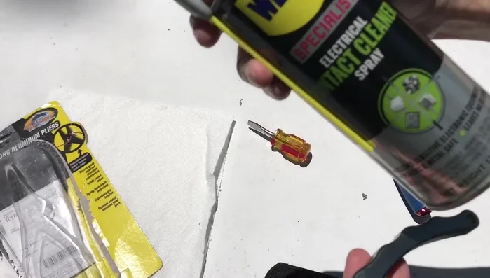 Pull apart the pliers to access the spring and washer.