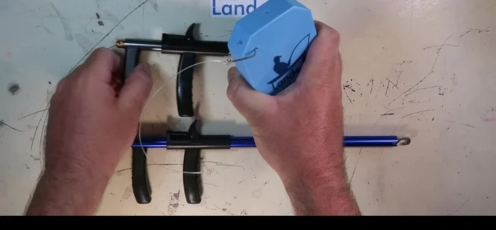 Position the hook remover onto the line, following it down to the hook.