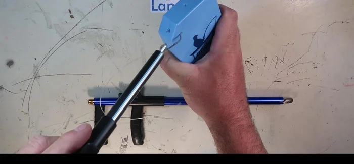 Position the hook remover onto the line, following it down to the hook.