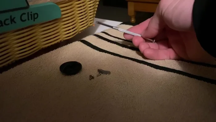 Remove the remaining screws and parts, keeping track of their order on the towel.