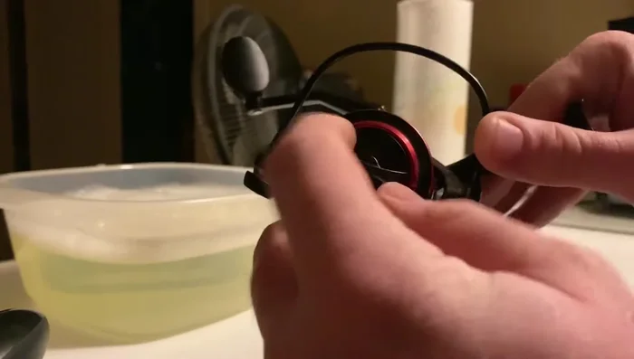 Remove the remaining screws and parts, keeping track of their order on the towel.