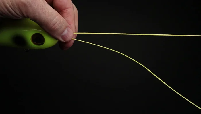 Create a loop by laying the end of the line over the main line and pinch all three lines together.