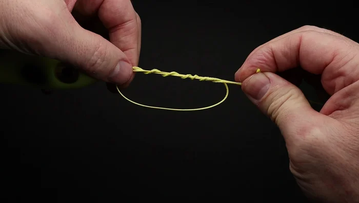 Pull on the end of the line just until the knot forms, being careful not to tighten the knot down yet.