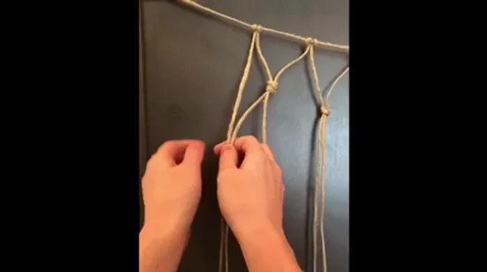 Continue tying adjacent strings together down the entire length of the net, following the established pattern.