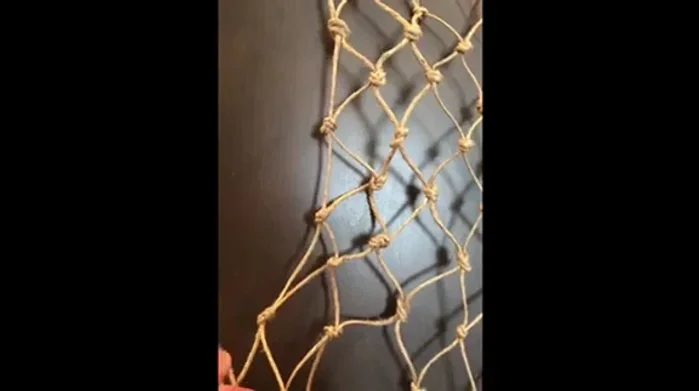 Trim the excess string from the completed net.