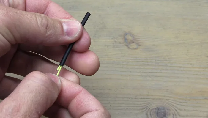 Using a lighter, evenly heat the heat shrink tubing to shrink it around the fly line. Avoid heating the fly line itself at this stage.