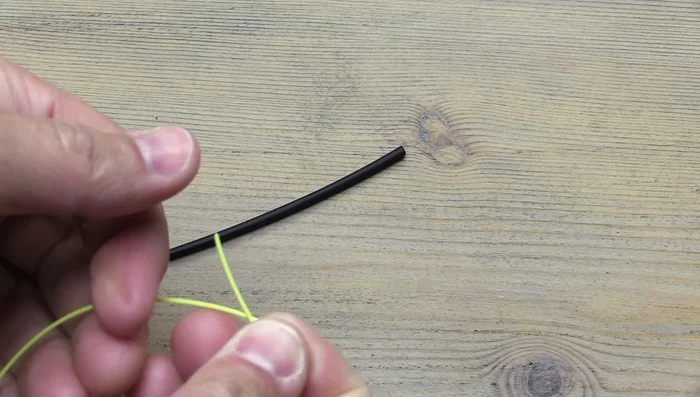 Fold over about an inch of the fly line.