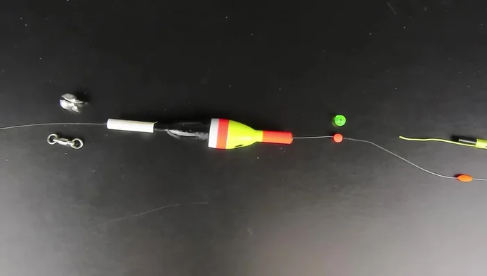 Run your line through a bobber stop, a plastic bead, the top and bottom of the bobber. Add a small split shot sinker or swivel for weight to prevent tangling. Then tie on your hook or jig.