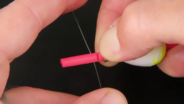 Pull the spring down to expose a notch, thread your line through the notch, and release the spring. You can wrap the line around if it slips.