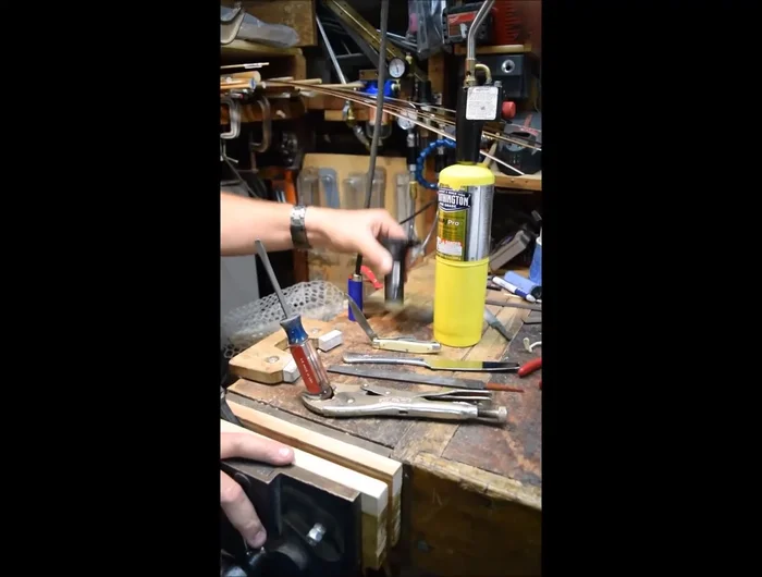 Heat your flat piece of metal using your chosen heat source. Aim for a temperature where the net material will melt, but avoid overheating (blackening indicates excessive heat).