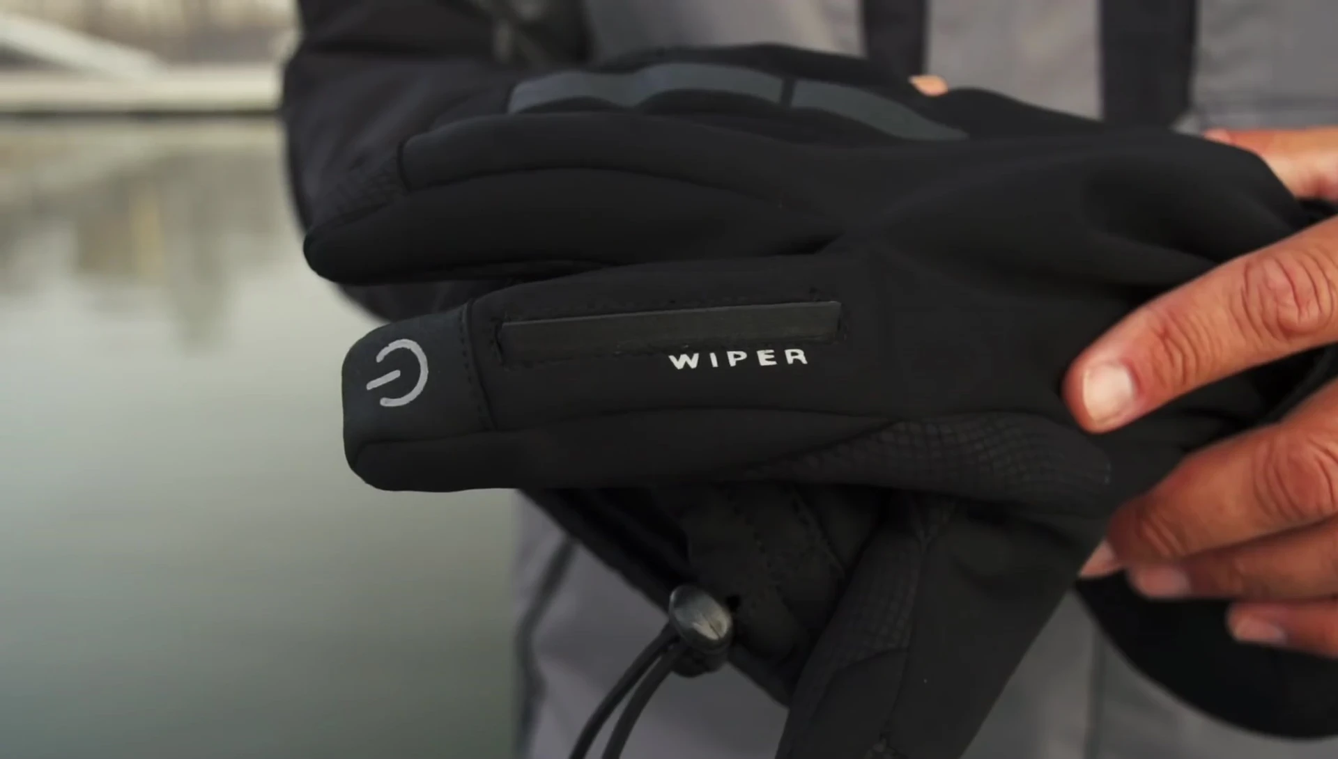 Demonstration of the gloves' integrated screen wipe.