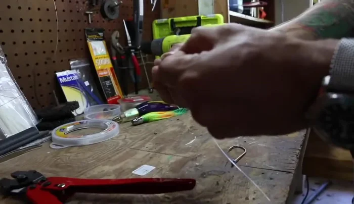 Slide the crimp onto the leader line, leaving a small tag end.