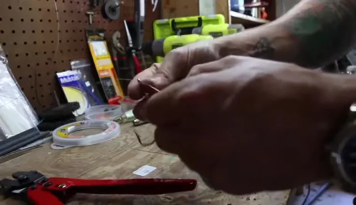 Attach your hook, snap, or swivel through the crimp and back through the loop.