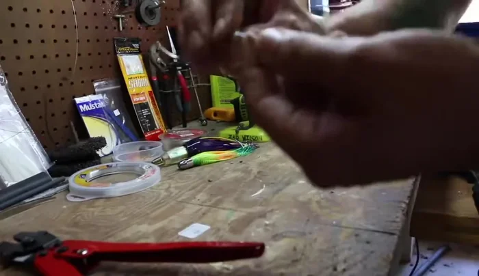 Pull the crimp down tightly close to the base, ensuring the line is flat and not twisted.