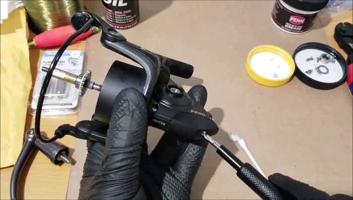 Remove the side plate (four screws). Visually inspect for sand; remove with a Q-tip if necessary.