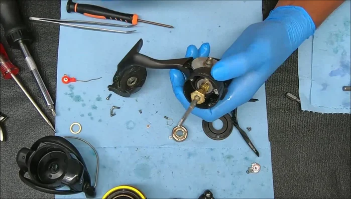 Use a nut on the pinion to help remove the gear assembly.