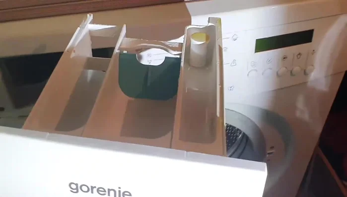 Measure the correct amount of Revivex Pro Cleaner (or similar) according to the product's instructions. For 3 items (e.g., waders, jacket, pants), use approximately 15ml. Add to the washing machine's fabric softener dispenser.