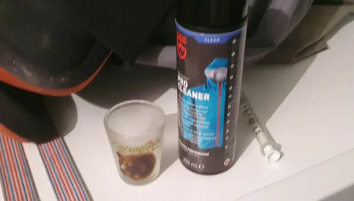 Measure the correct amount of Revivex Pro Cleaner (or similar) according to the product's instructions. For 3 items (e.g., waders, jacket, pants), use approximately 15ml. Add to the washing machine's fabric softener dispenser.