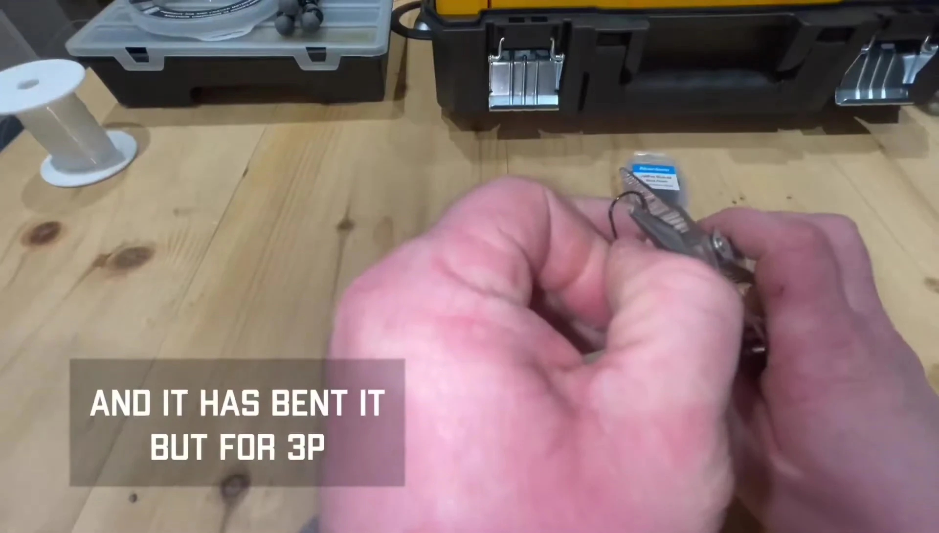 A close-up shot of a bent cheap Aberdeen hook.