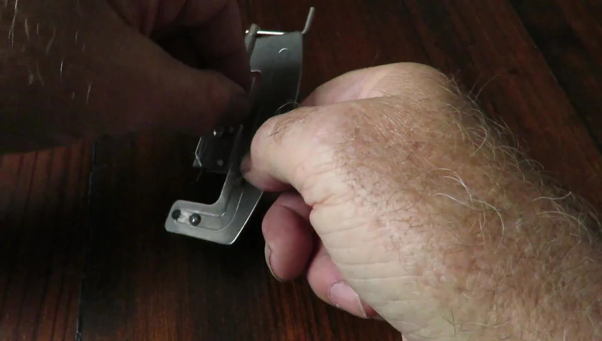 Showing the line being guided around the hook and bail.