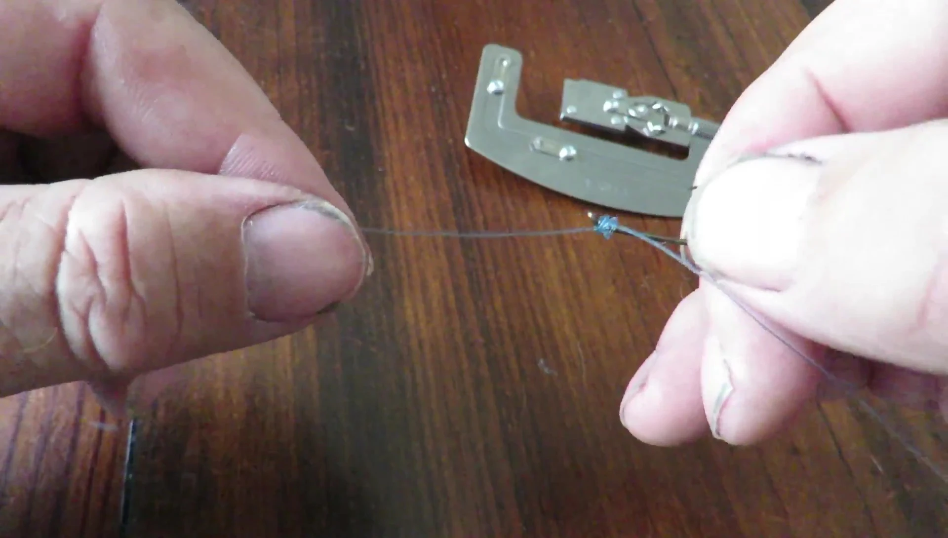 The presenter holding the tied hook.