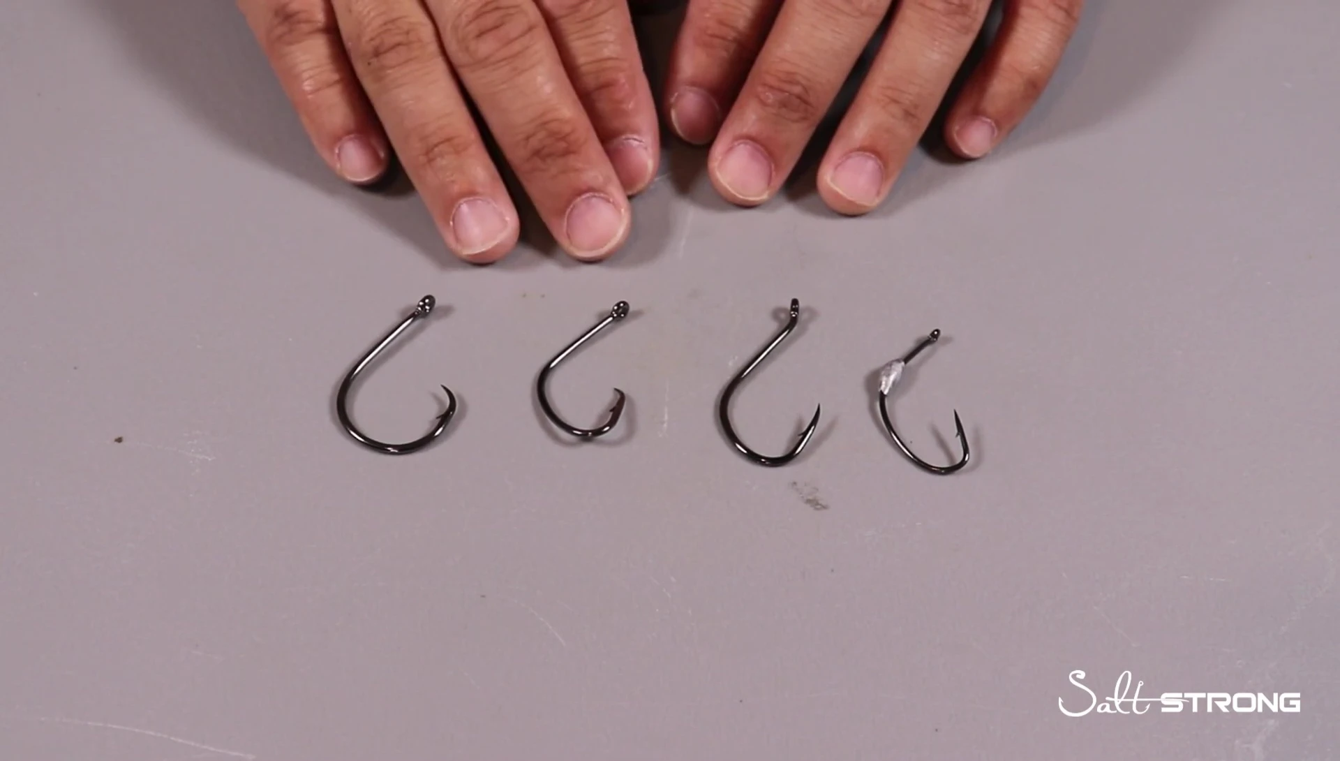 Close-up of various hook sizes next to bait
