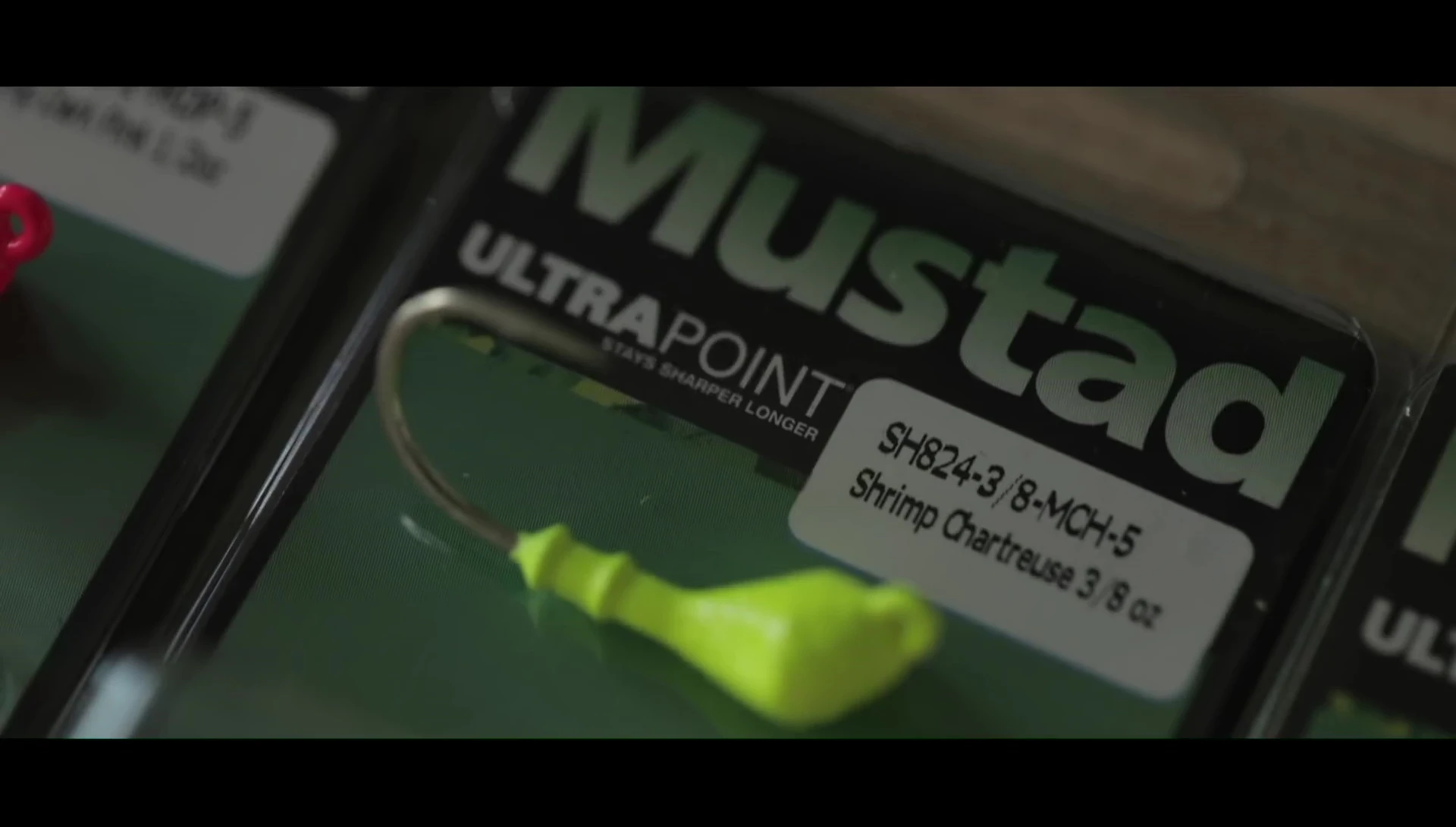 Angler demonstrating the use of different jig head weights.