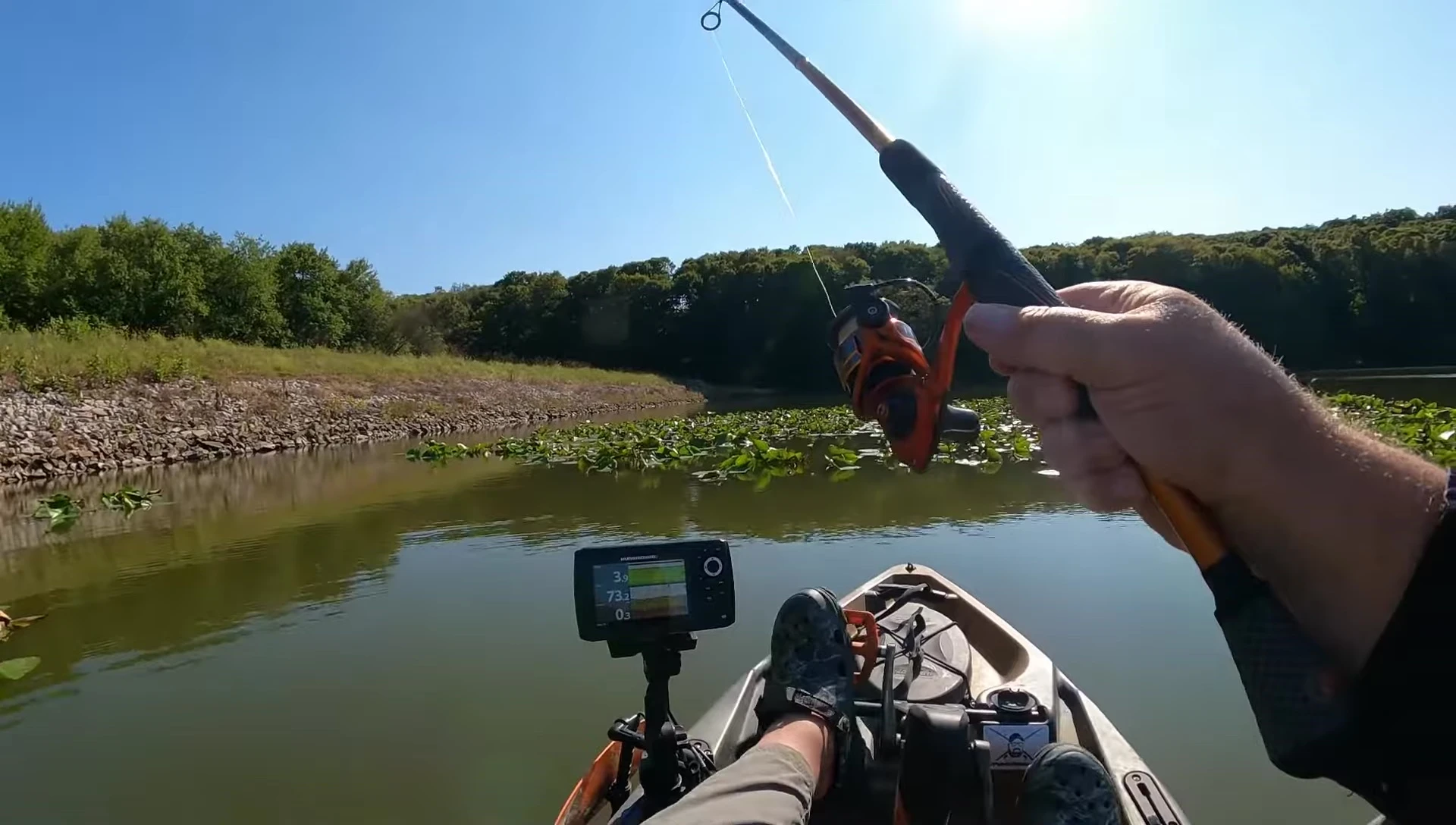 Angler's hand holding the spinning rod, showcasing the grip