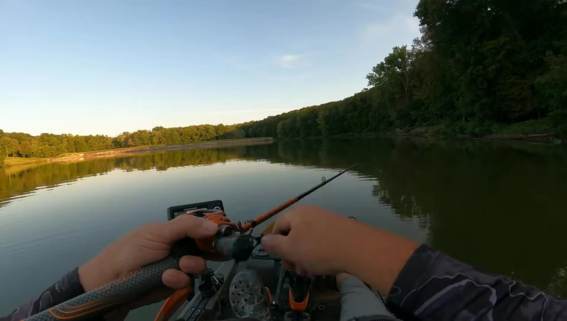 Angler demonstrating baitcasting rod's tip action while retrieving a Chatterbait