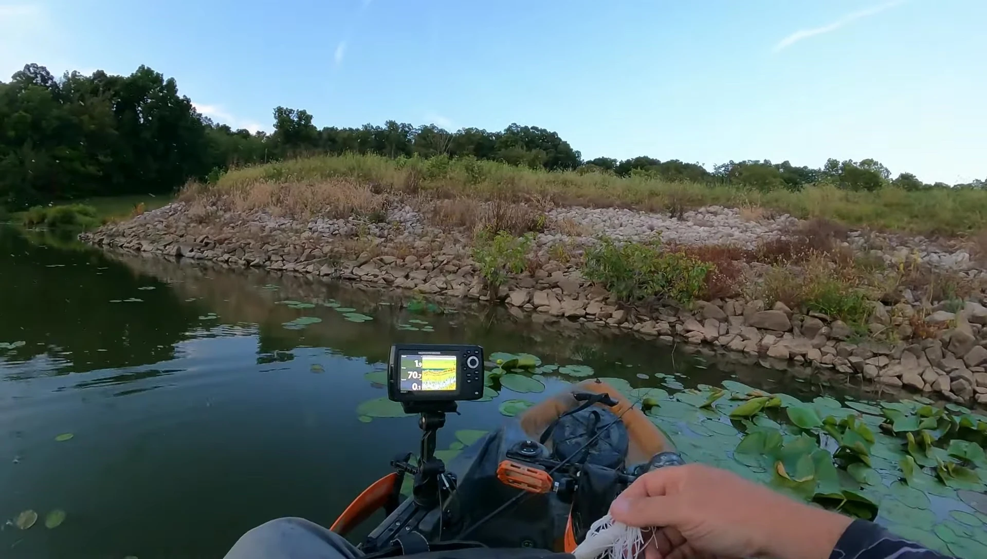 Angler holding both spinning and baitcasting combos side-by-side