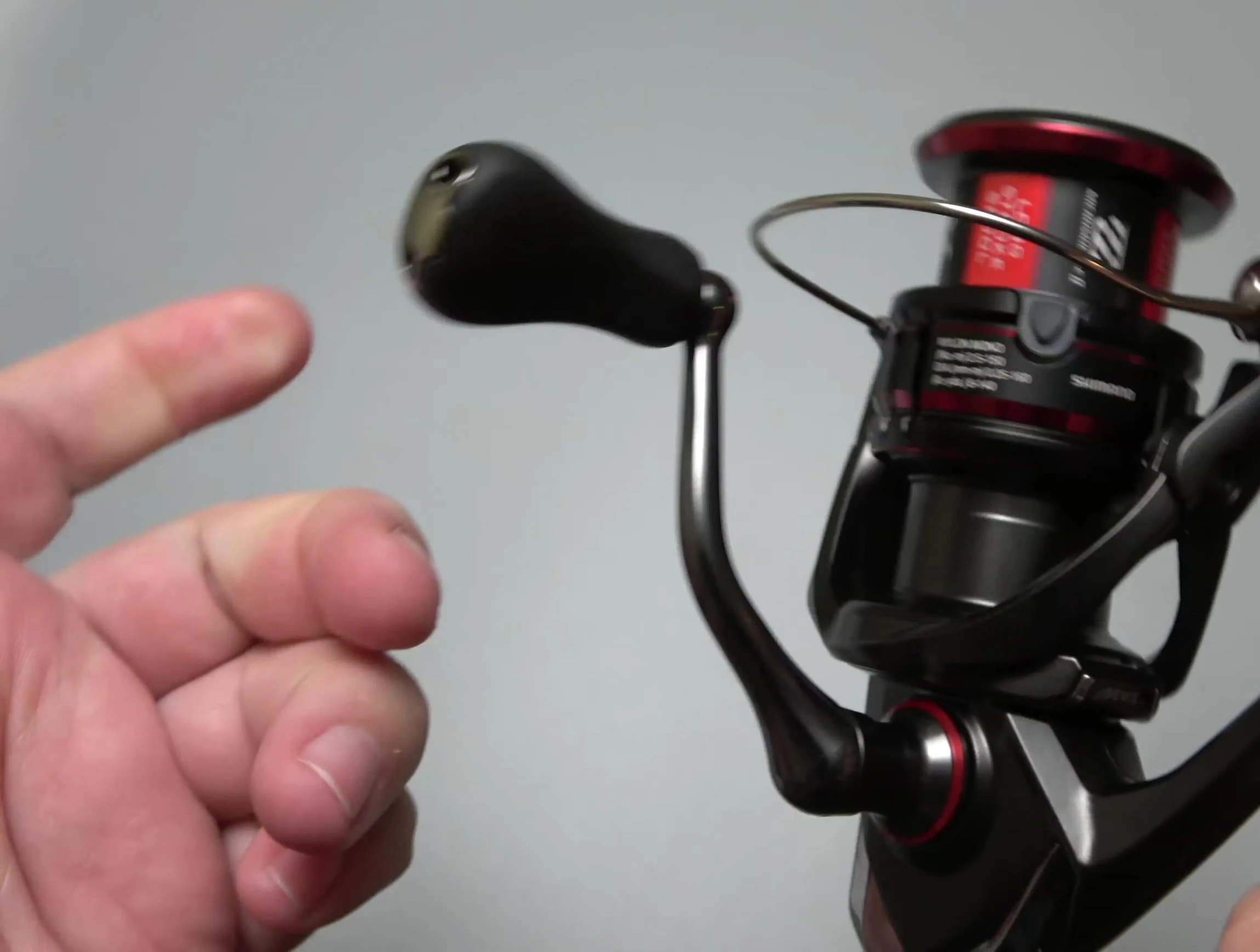 Close-up of the reel's handle, highlighting its ergonomic design.