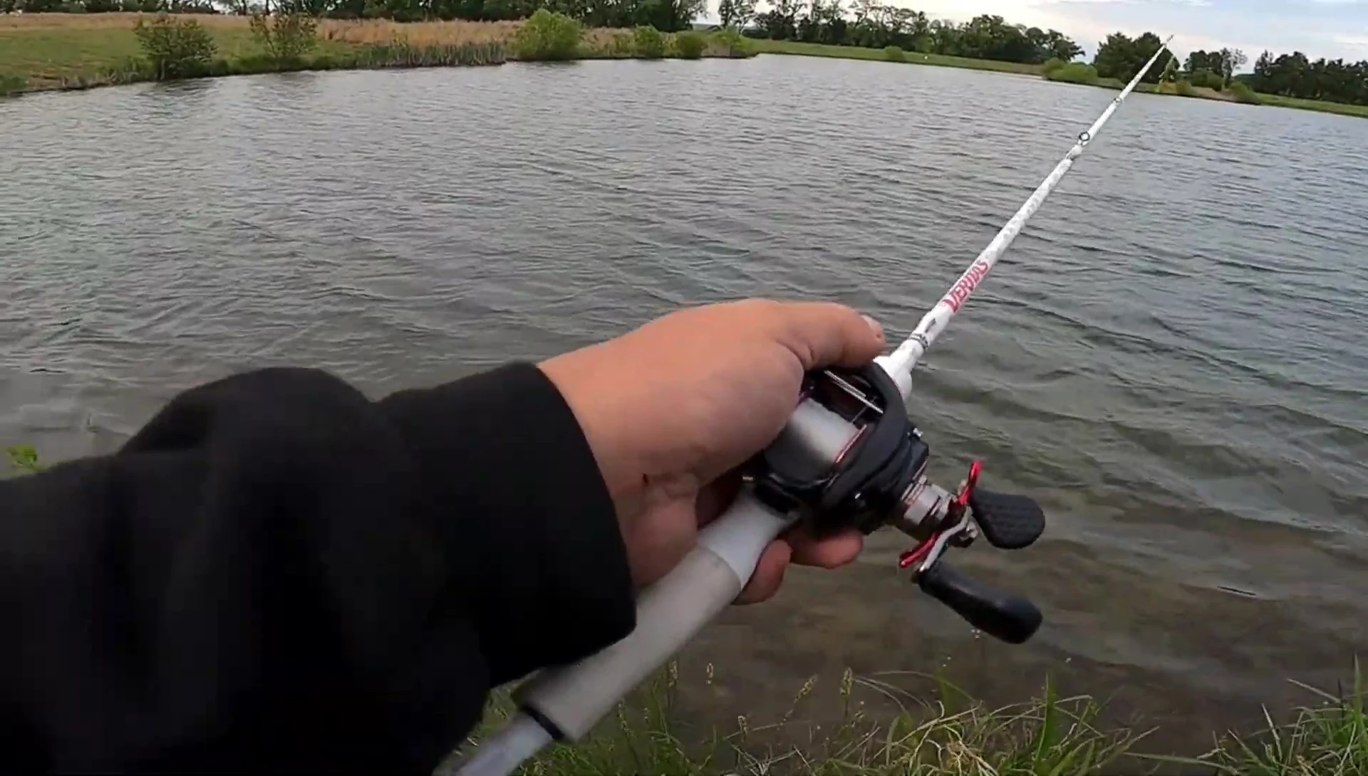 Fisherman holding the reel, showcasing its comfortable grip