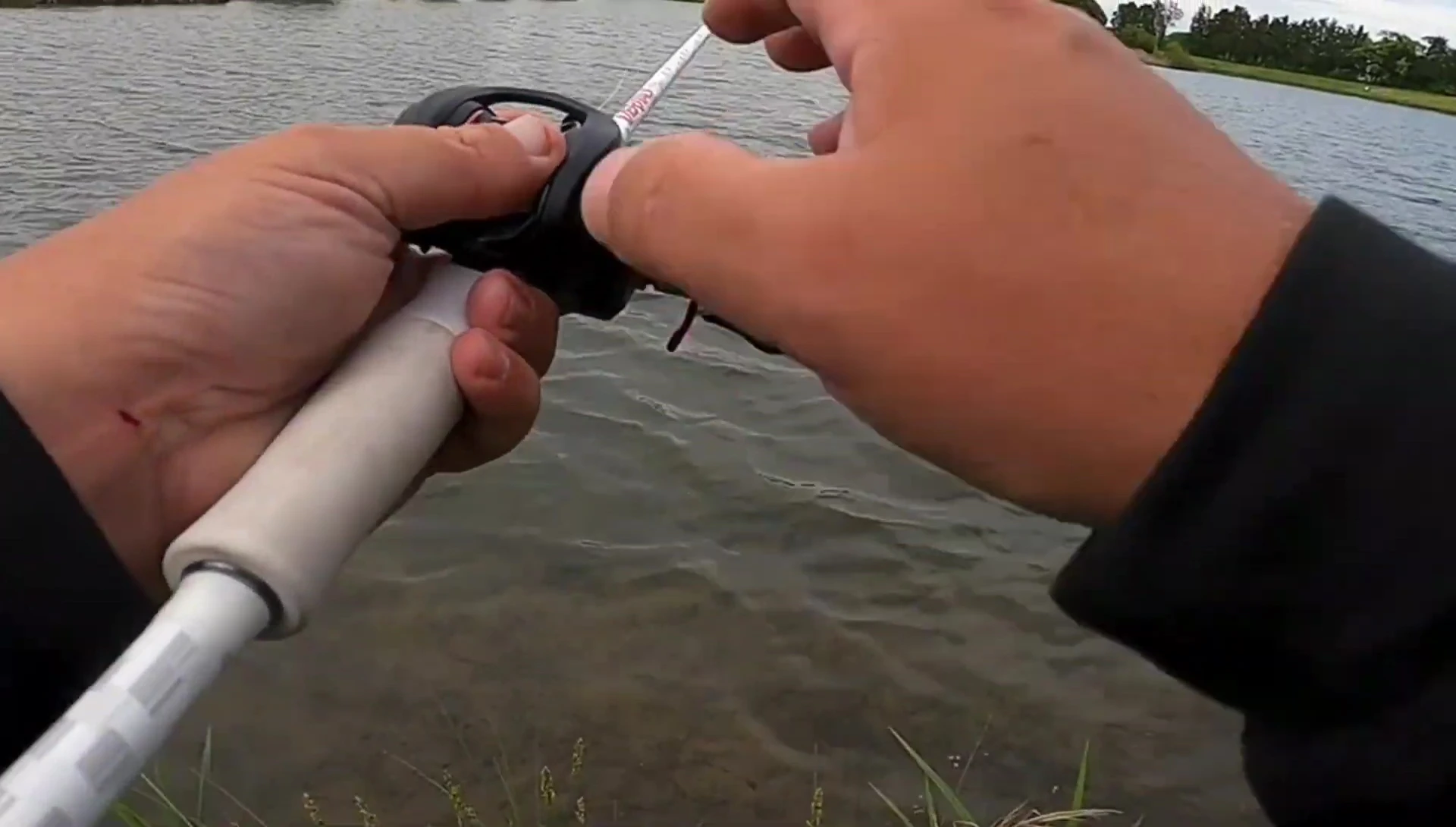 Close-up of the reel's tensioner button