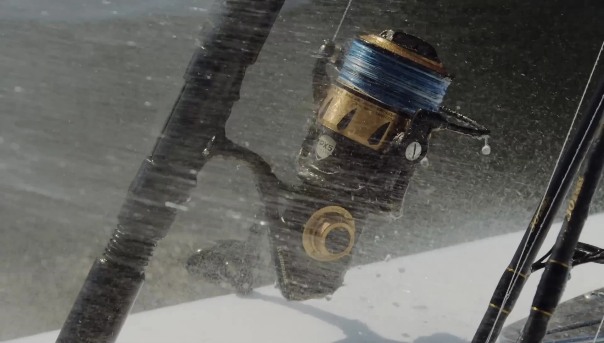 Image showing someone rinsing a fishing reel