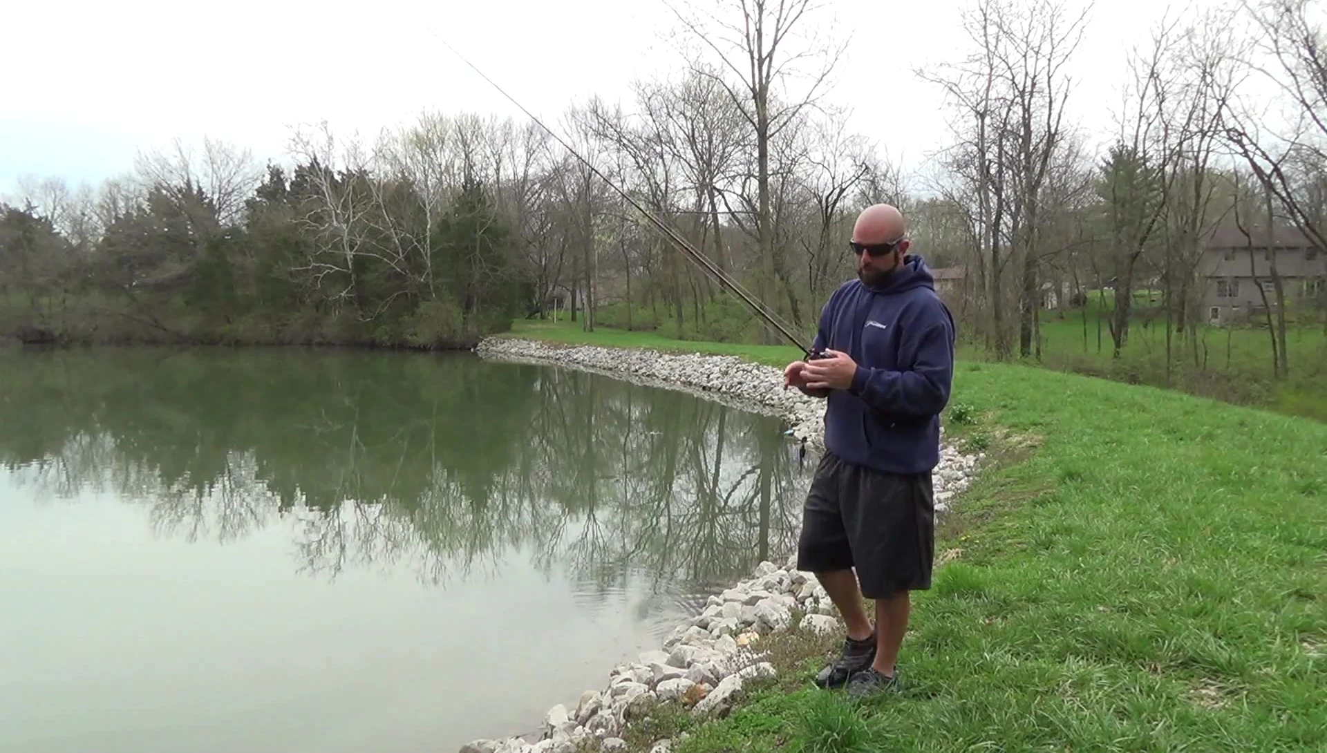 Angler's hands holding the reel after fishing