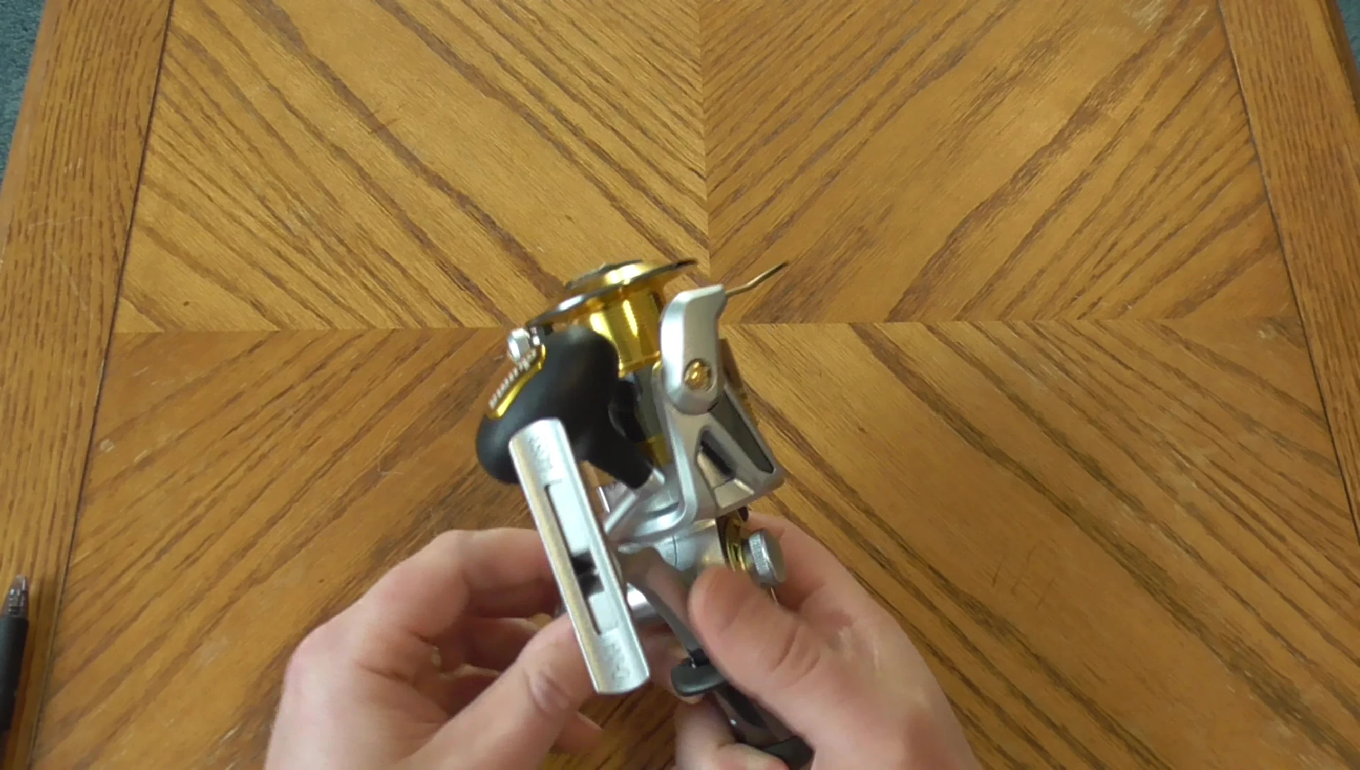 The reel's handle, showing its left-hand configuration.