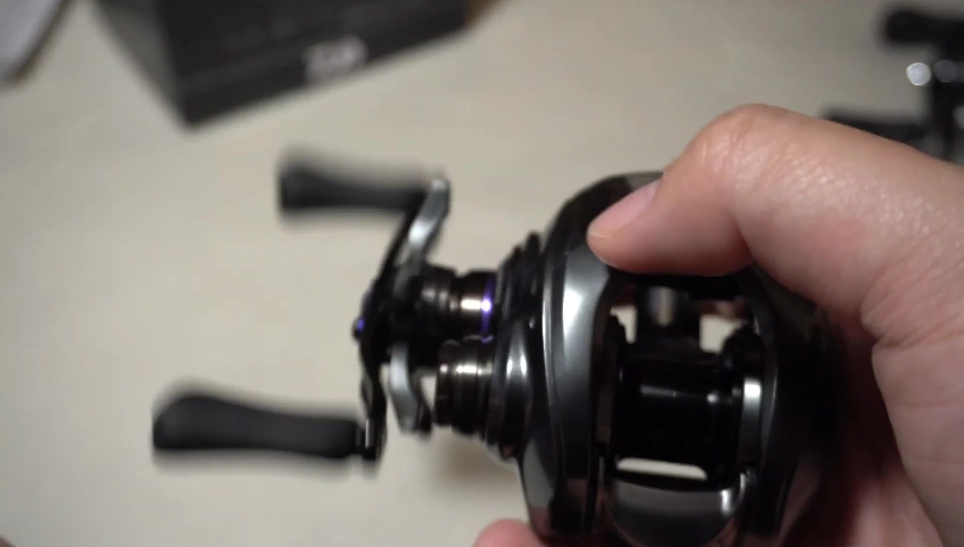 Angler holding the reel, showcasing the overall design and size.
