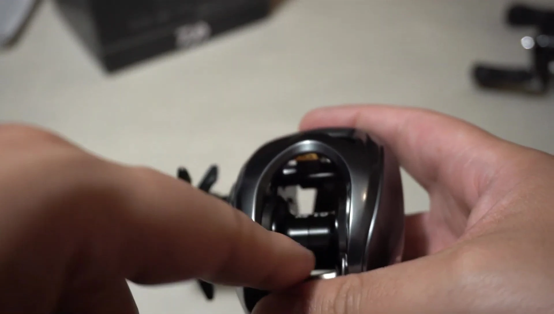 Close-up shot of the reel's spool, emphasizing its small size.