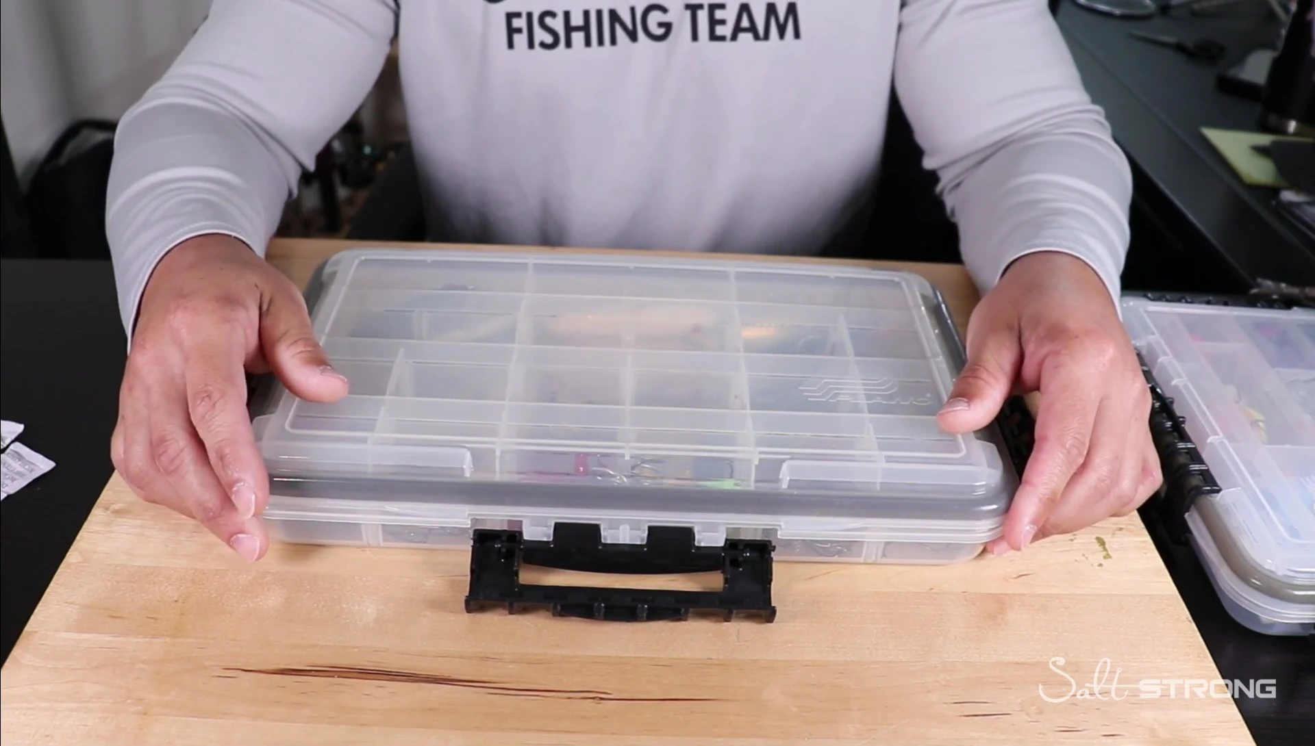 Angler inspecting the inside of the Plano StowAway box