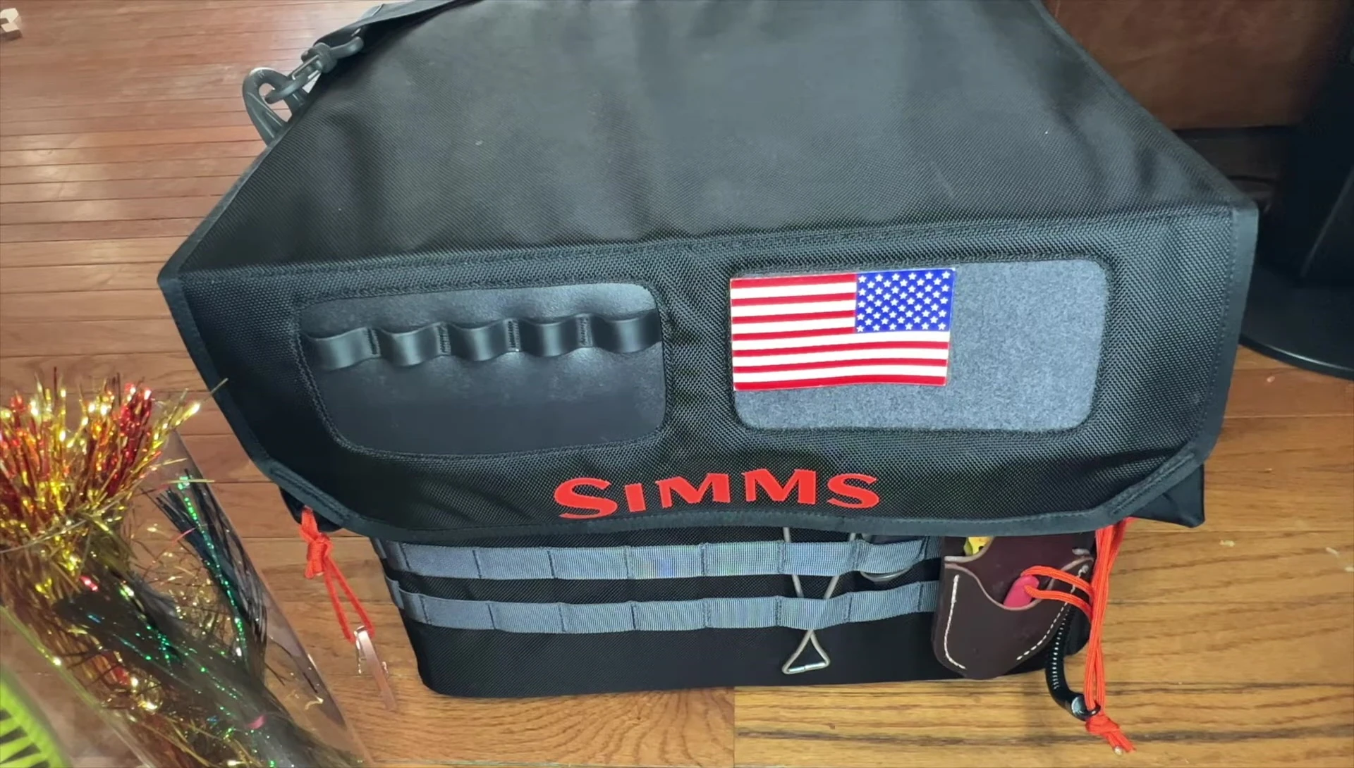 Close-up shot highlighting the MOLLE webbing and tactical features of the bag.