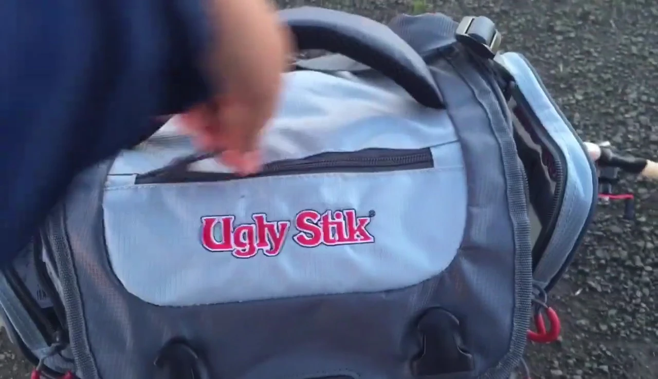 The smaller, zipped pocket.