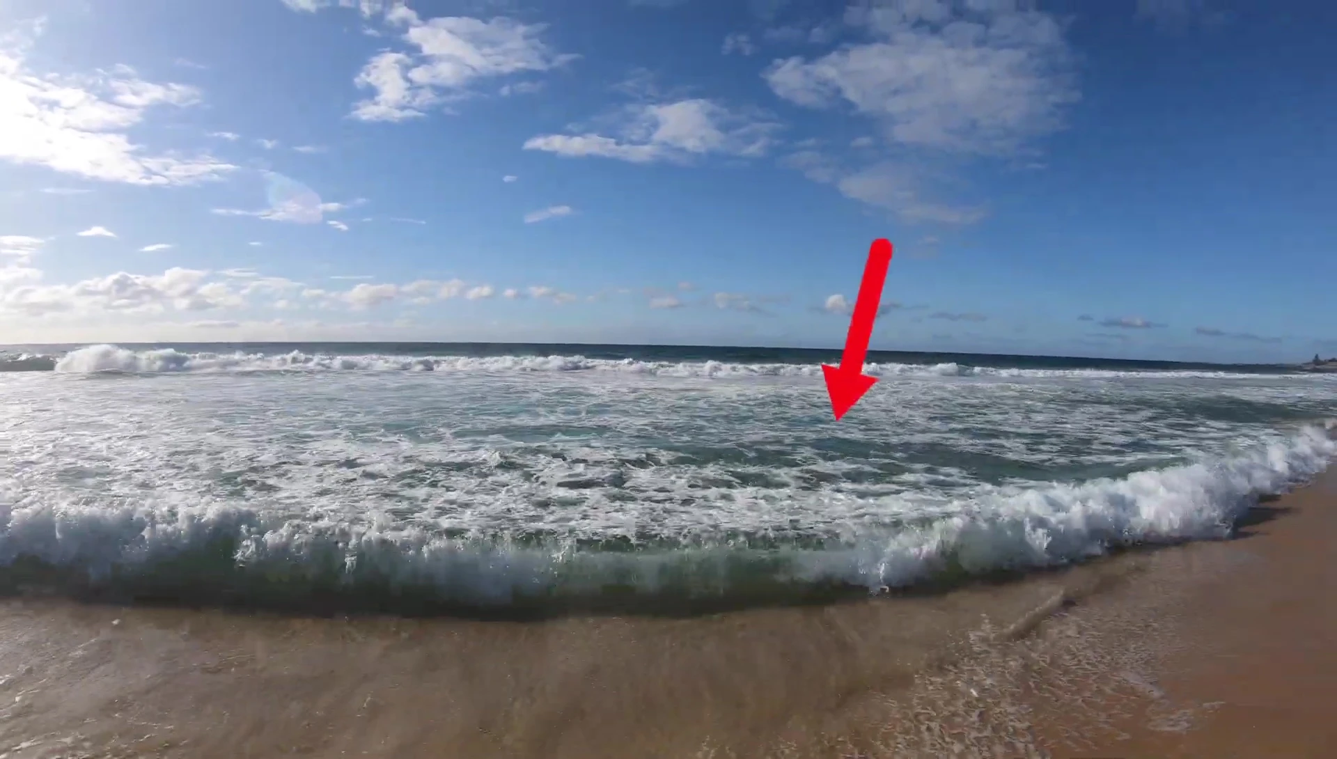The YouTuber pointing towards the deeper water area